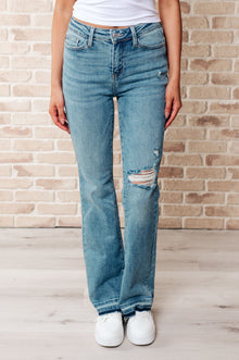  Isla Mid Rise Distressed Released Hem Bootcut Jeans